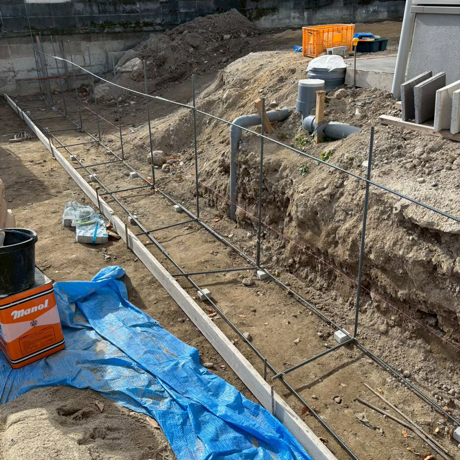 滋賀県大津市の新築外構現場。土留めブロックを積む前に組み上げられた基礎の鉄筋（配筋）の様子。