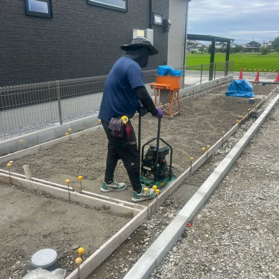 滋賀県草津市の新築旗竿地現場にて土間コンクリート施工のために型枠を組み転圧機で下地を固めている様子。