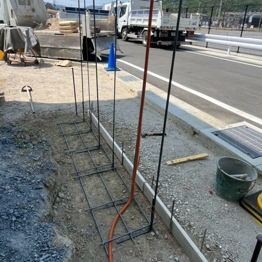 滋賀県湖南市の新築外構現場にて造作門柱の基礎鉄筋組みと配管を行う施工風景。